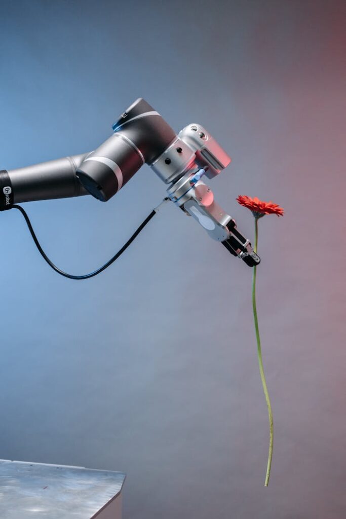 A robotic arm delicately holding a single red flower, symbolizing harmony between technology and nature.